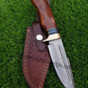 A close-up view of the Damascus steel blade and rosewood handle of the handcrafted knife.