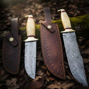 Hand-forged Damascus hunting knives with polished bone handles and leather sheaths – custom crafted by Damascus Edges.